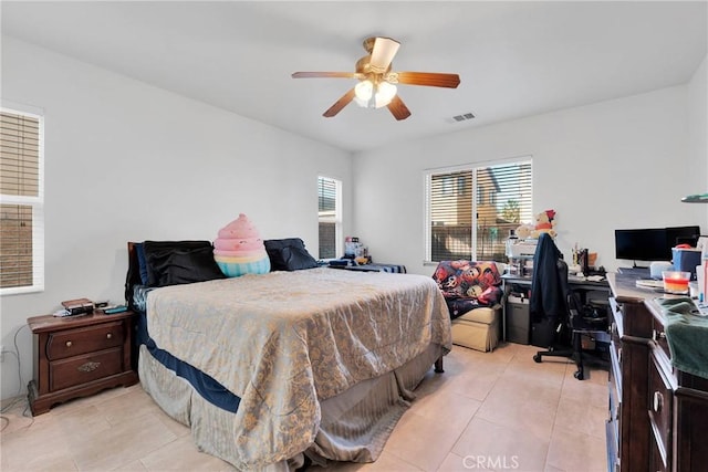 bedroom with visible vents, ceiling fan, and light tile patterned floors