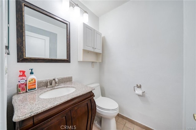 half bath featuring tile patterned flooring, vanity, and toilet