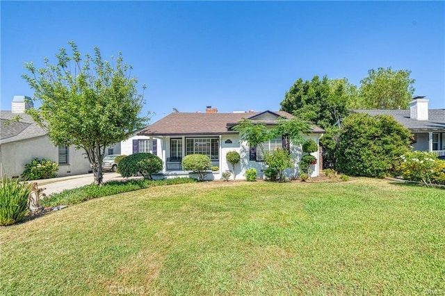 single story home with a chimney and a front yard