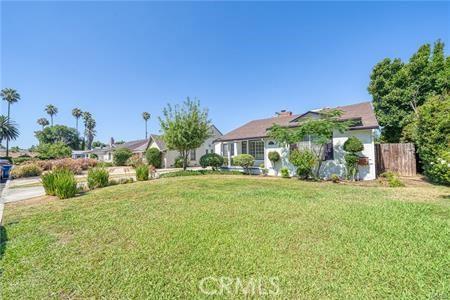 view of front of property with fence and a front lawn