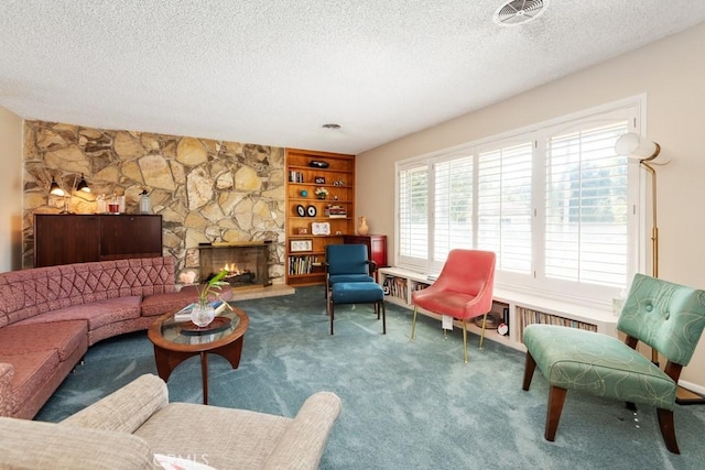 carpeted living room featuring visible vents, a textured ceiling, and a stone fireplace