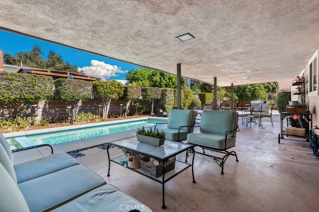 view of patio with a fenced backyard, an outdoor pool, and an outdoor living space