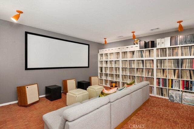 home theater with baseboards, visible vents, and carpet flooring