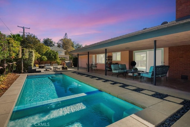 view of pool with a pool with connected hot tub, a patio, and an outdoor hangout area