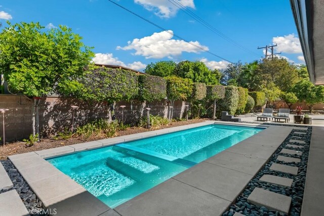 view of swimming pool with a patio area, a fenced backyard, and a fenced in pool