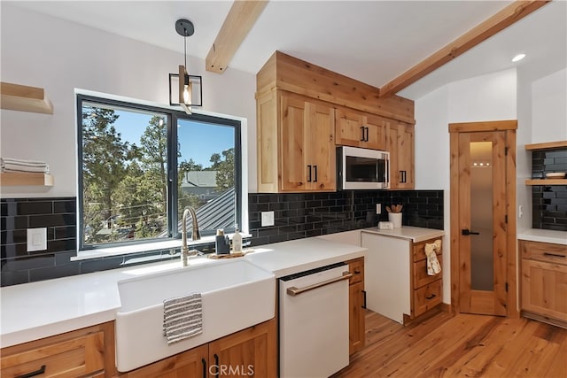 kitchen with a sink, beam ceiling, dishwasher, open shelves, and stainless steel microwave