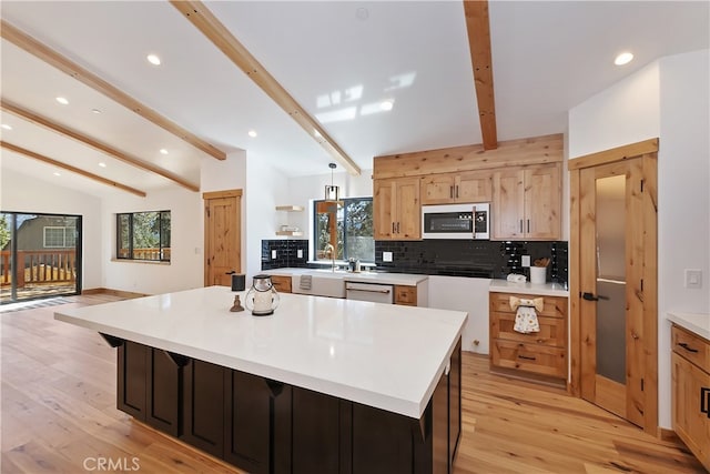 kitchen with tasteful backsplash, dishwasher, lofted ceiling with beams, stainless steel microwave, and a healthy amount of sunlight