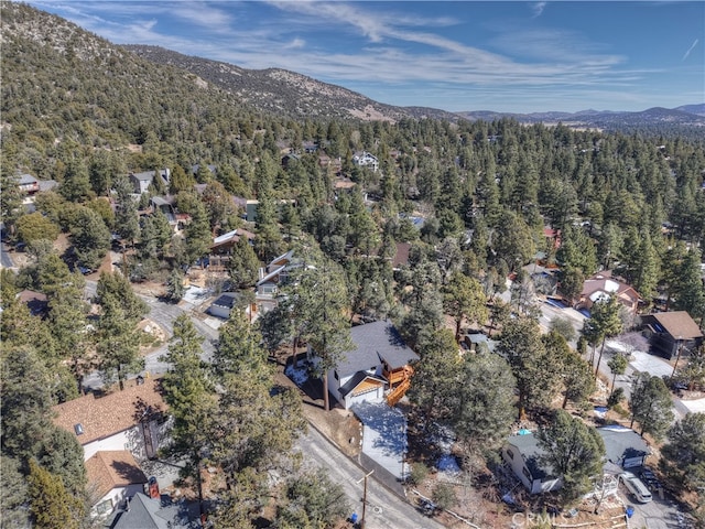 drone / aerial view with a mountain view and a view of trees