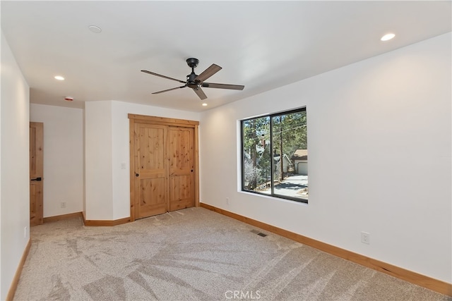 unfurnished bedroom with recessed lighting, carpet, visible vents, and baseboards