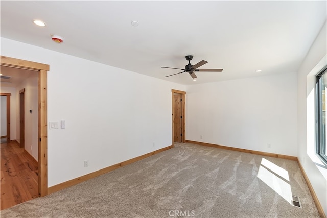 spare room with baseboards, light colored carpet, and recessed lighting