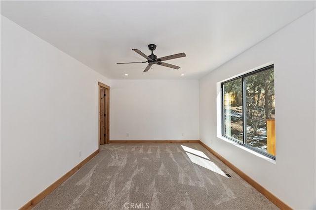 carpeted spare room featuring ceiling fan, visible vents, baseboards, and recessed lighting