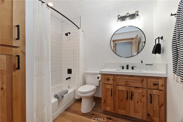 bathroom with toilet, vanity, wood finished floors, and shower / tub combo with curtain