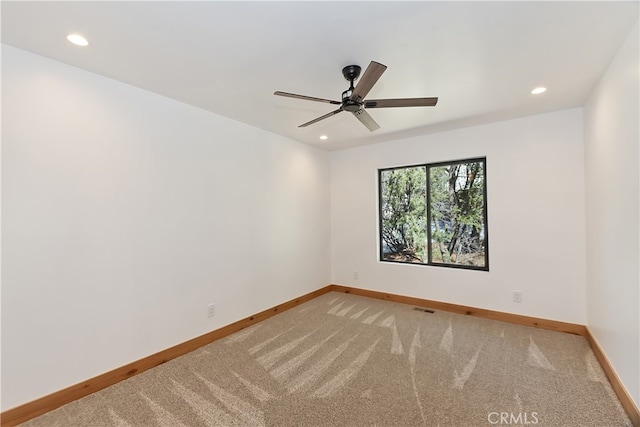 spare room featuring visible vents, recessed lighting, light colored carpet, and baseboards