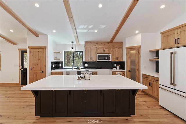 kitchen with a spacious island, high end white fridge, backsplash, open shelves, and beamed ceiling