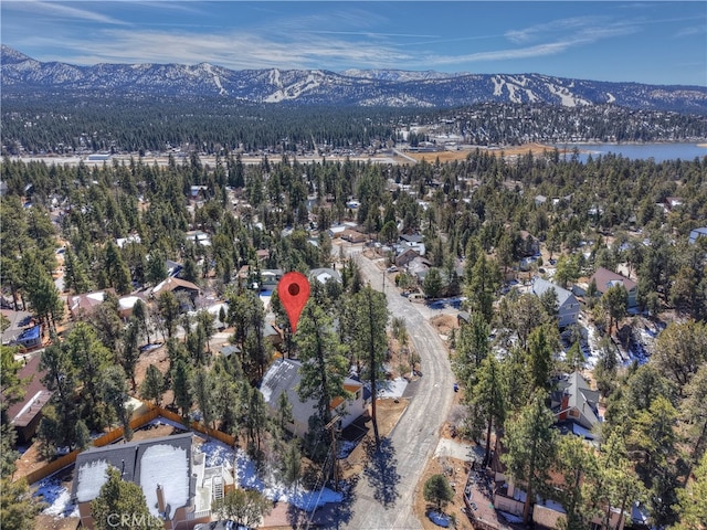 birds eye view of property with a water and mountain view