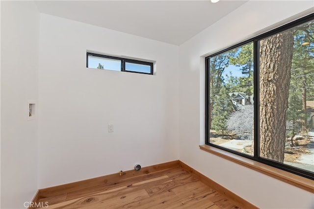 empty room featuring light wood-type flooring and baseboards