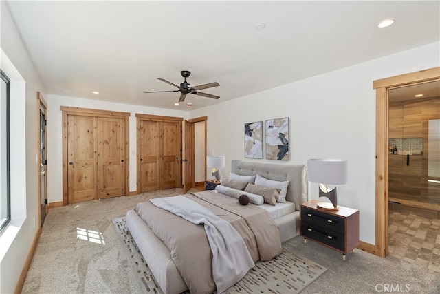 bedroom with baseboards, a ceiling fan, light colored carpet, two closets, and recessed lighting