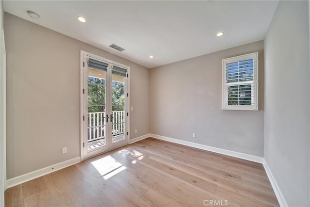 empty room with recessed lighting, visible vents, baseboards, and wood finished floors