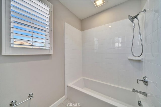 bathroom featuring washtub / shower combination and baseboards