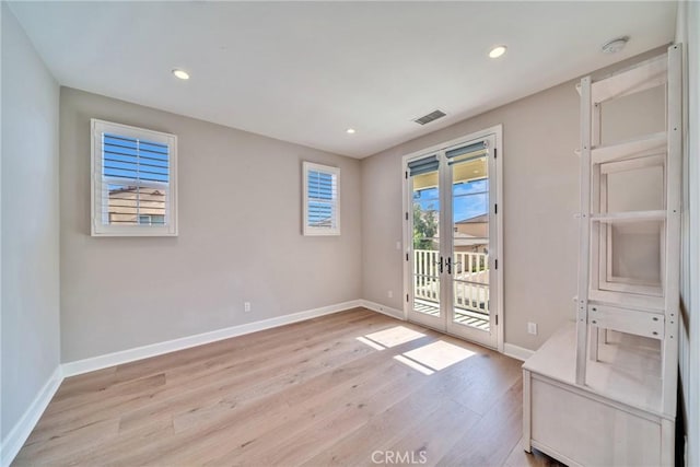 interior space with recessed lighting, baseboards, visible vents, and light wood finished floors