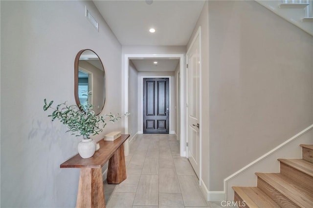 interior space featuring recessed lighting, visible vents, baseboards, and stairs