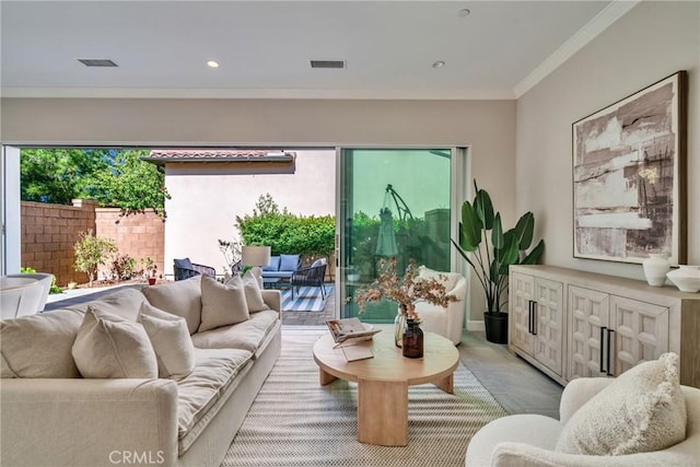 living room with visible vents and ornamental molding