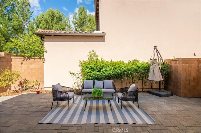 view of patio / terrace featuring fence and an outdoor living space