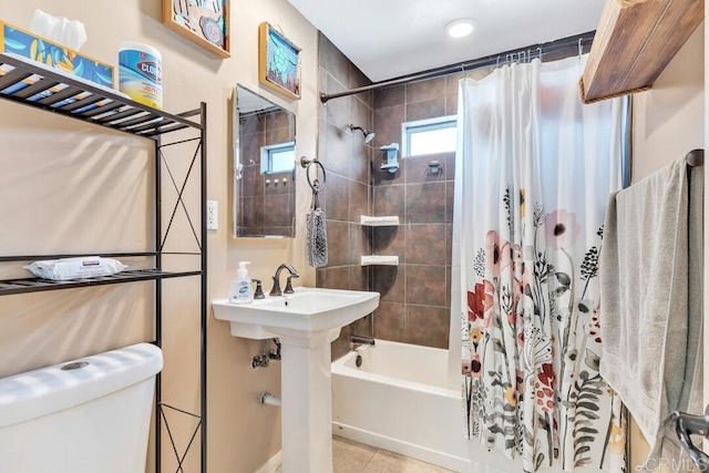 bathroom featuring tile patterned flooring, toilet, and shower / tub combo with curtain