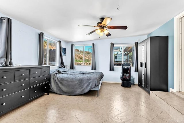 bedroom with baseboards, ceiling fan, and light tile patterned flooring