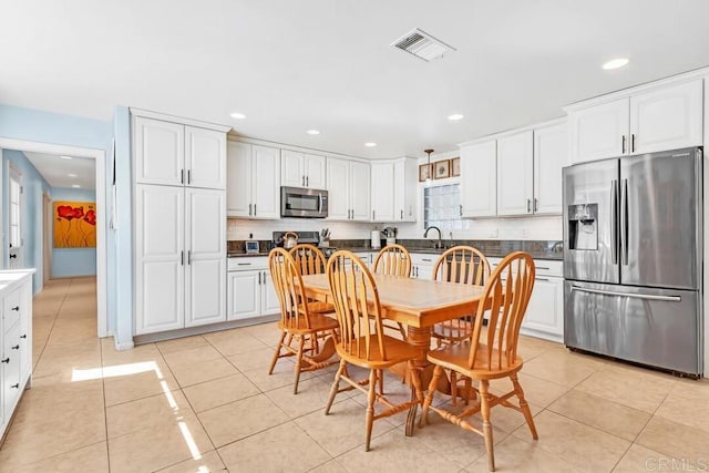 dining area with light tile patterned floors, visible vents, and recessed lighting