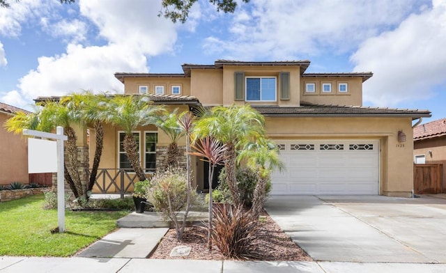 view of front facade featuring fence, driveway, stucco siding, a garage, and a tile roof