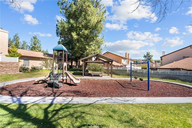 community play area featuring a gazebo, a lawn, and fence