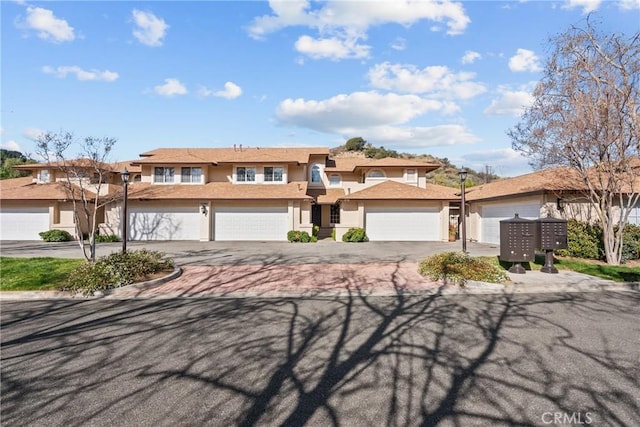 view of front facade with a garage and stucco siding