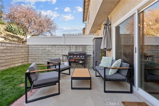 view of patio with a grill, an outdoor living space, and a fenced backyard