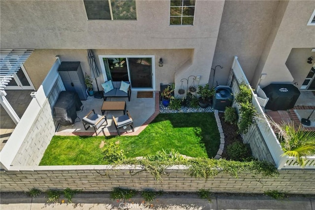 doorway to property featuring a patio, a lawn, and stucco siding