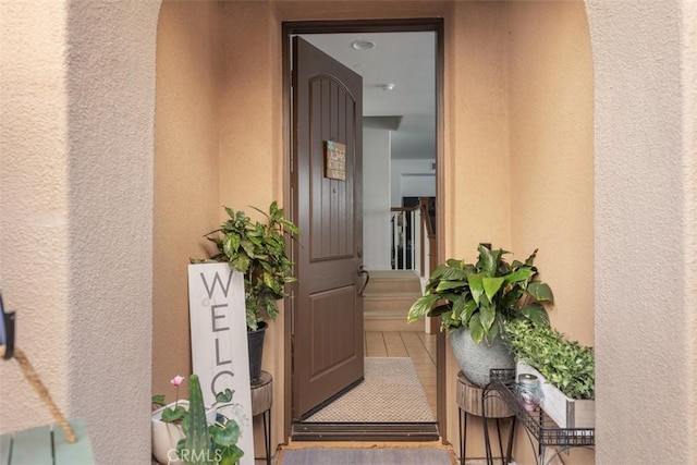 property entrance featuring stucco siding