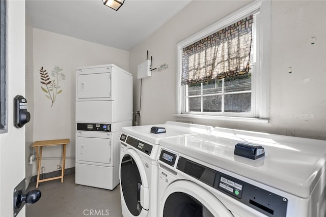 common laundry area featuring stacked washer / drying machine and washer and clothes dryer