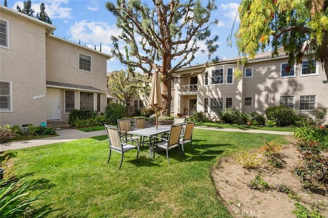 exterior space with entry steps and a yard