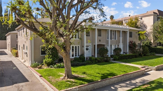 view of front of house featuring a front yard and stucco siding