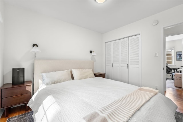 bedroom featuring a closet and wood finished floors