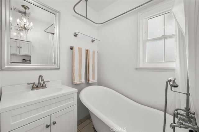 bathroom featuring a freestanding tub and vanity