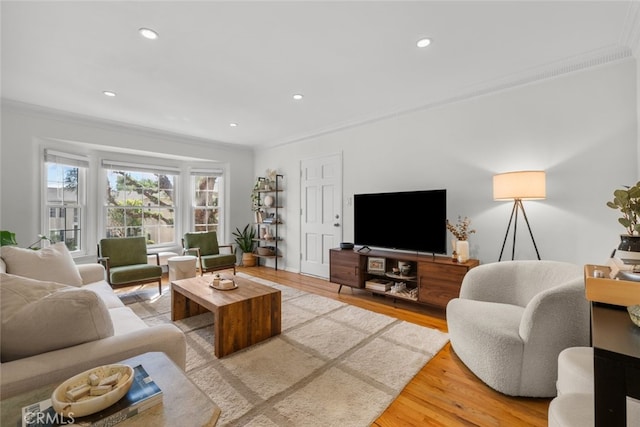 living area with recessed lighting, crown molding, and wood finished floors