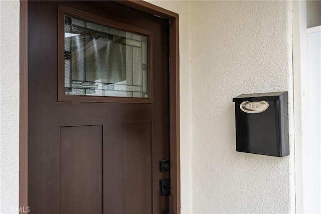 view of exterior entry with stucco siding