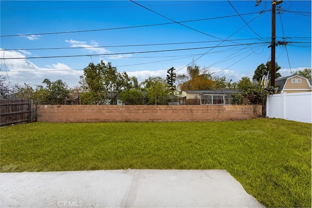 view of yard with a fenced backyard