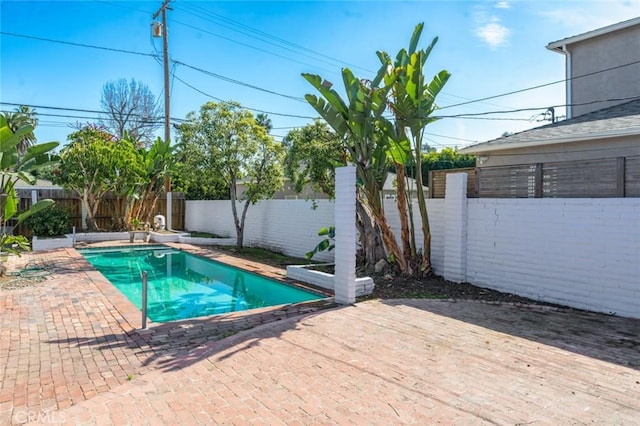 view of swimming pool with a fenced in pool, a patio area, and a fenced backyard