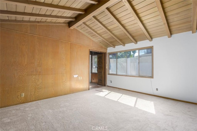 spare room with carpet floors, wood ceiling, vaulted ceiling with beams, and wood walls