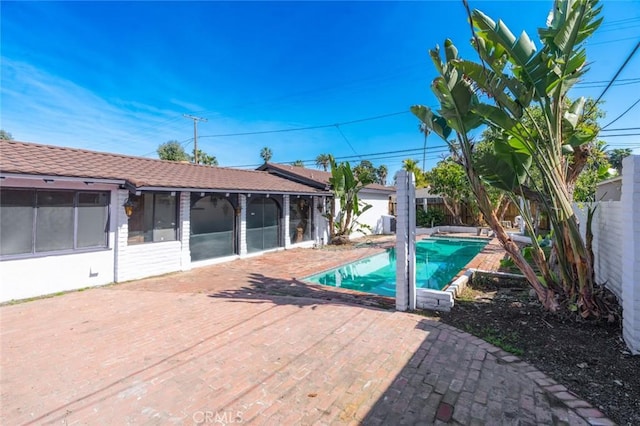 view of pool with a sunroom, a fenced backyard, and a fenced in pool