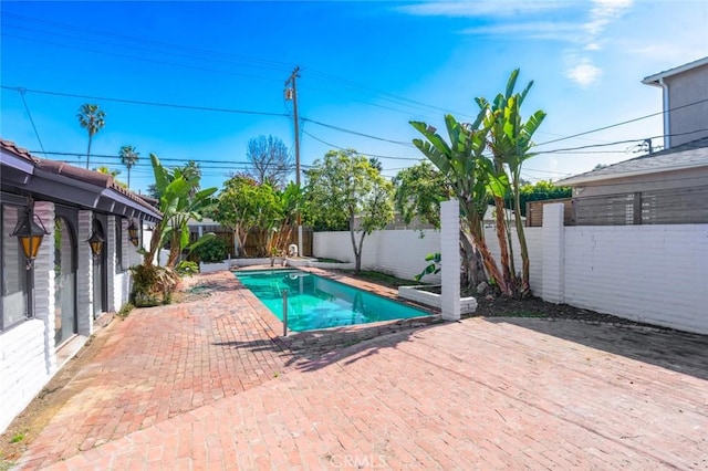 view of swimming pool with a patio, a fenced backyard, and a fenced in pool