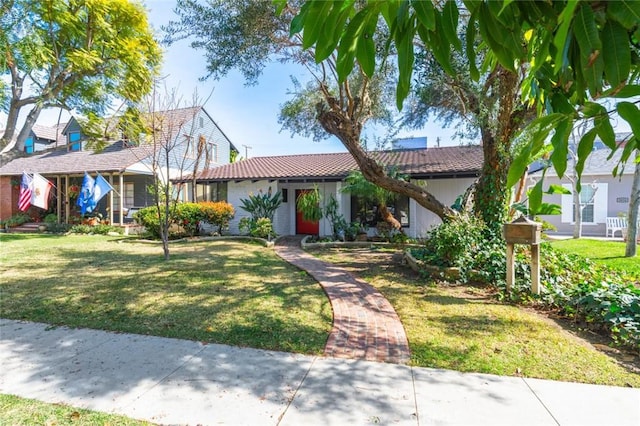 view of front of house featuring a front yard and a tile roof