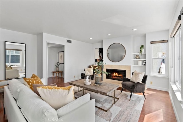 26B Surfside Ave, Surfside, CA 90743 - living area featuring light wood-style floors, a tile fireplace, baseboards, and recessed lighting